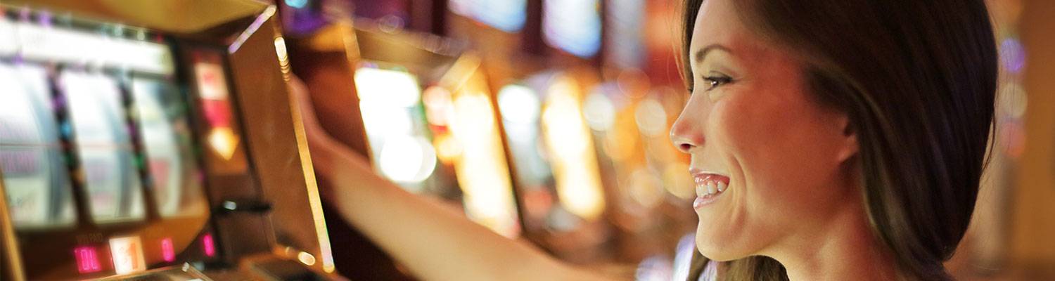 Woman playing slot machine | Casino & Gaming venue in Cross Lanes, WV