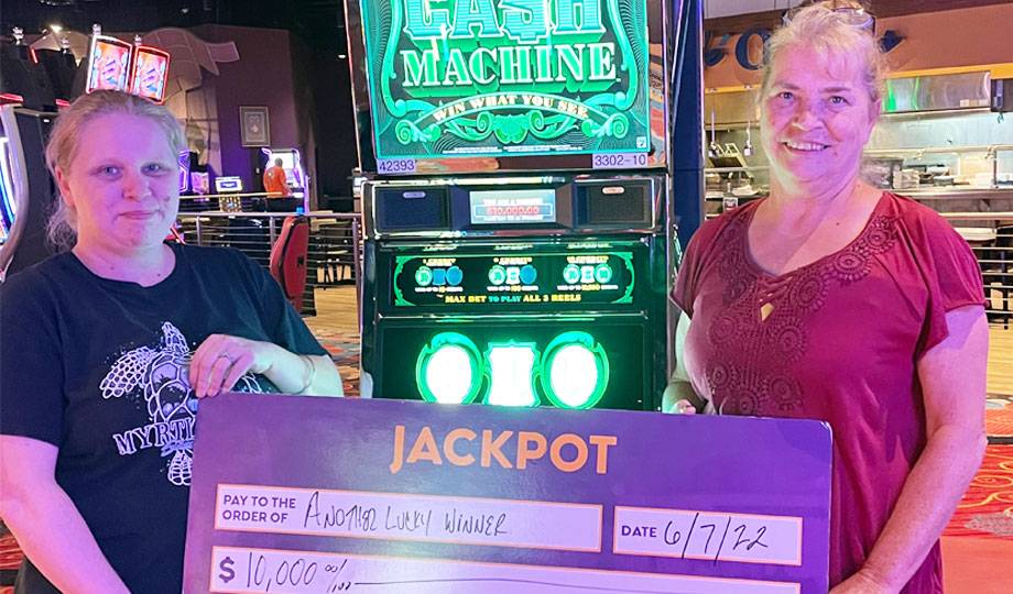 Winners - Jackpot winner with check for $10,000