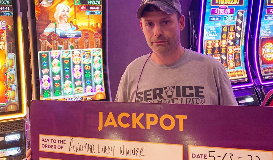 Winners - Jackpot winner with check for $11,449