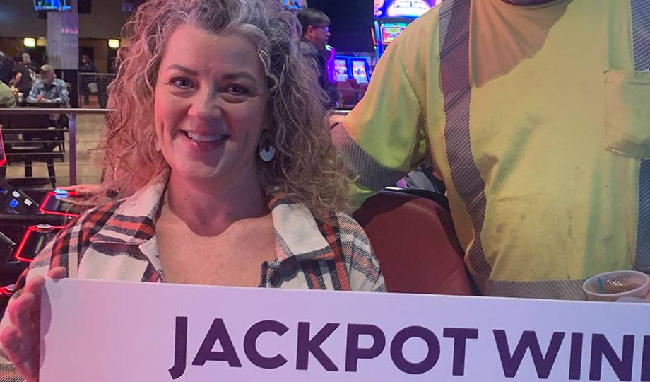 Winners - Jackpot winner with check for $17,116.46
