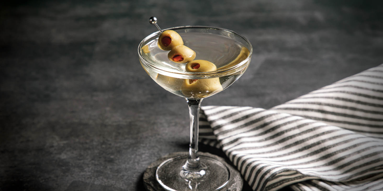 Picture of martini with olives in a glass